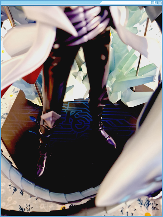 A shot of the base's logo with the assembled figure on it, as well as the rods